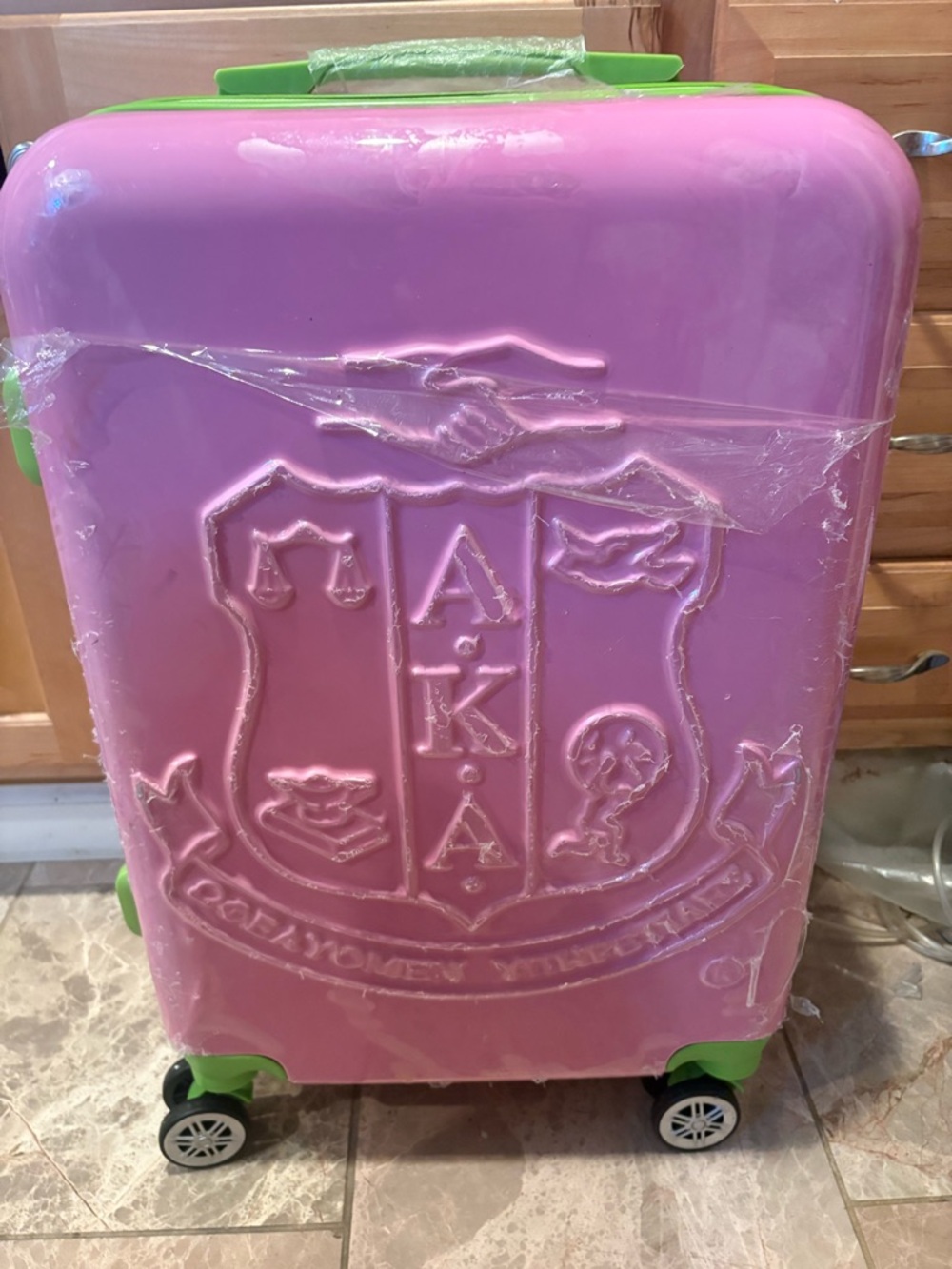 AKĀ Pink and Green Rolling Suitcase by